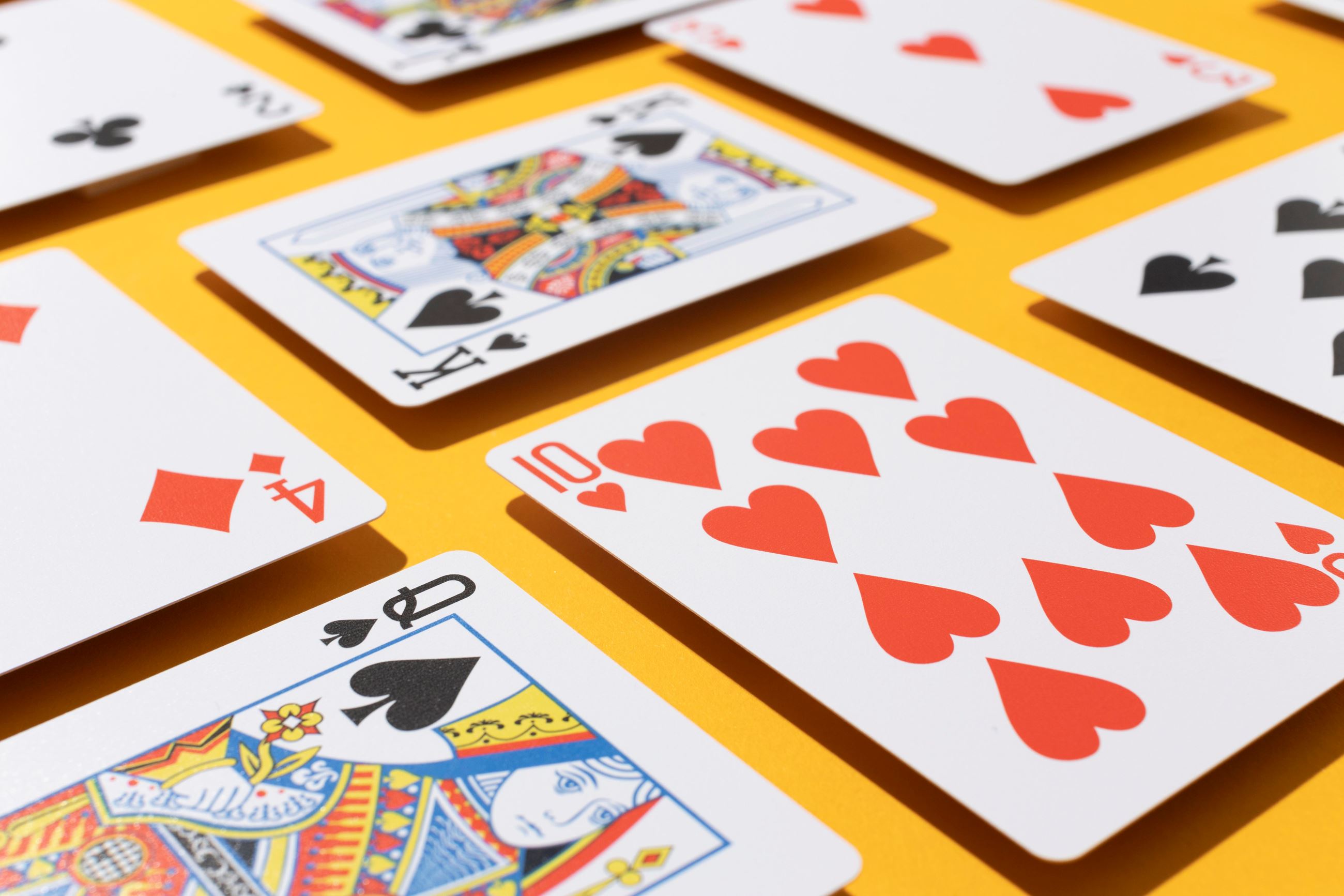 Variety of playing cards on a yellow background